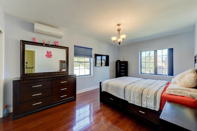 67-54 Groton St, Forest Hills, NY 11375 - bedroom featuring a chandelier, an AC wall unit, baseboards, and dark wood-style flooring