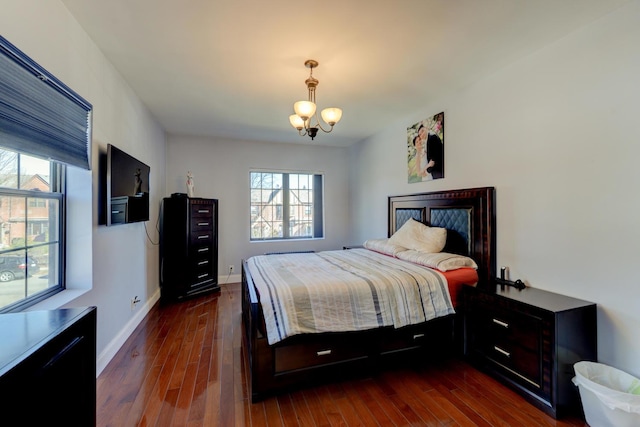 67-54 Groton St, Forest Hills, NY 11375 - bedroom with baseboards, dark wood-style floors, and an inviting chandelier