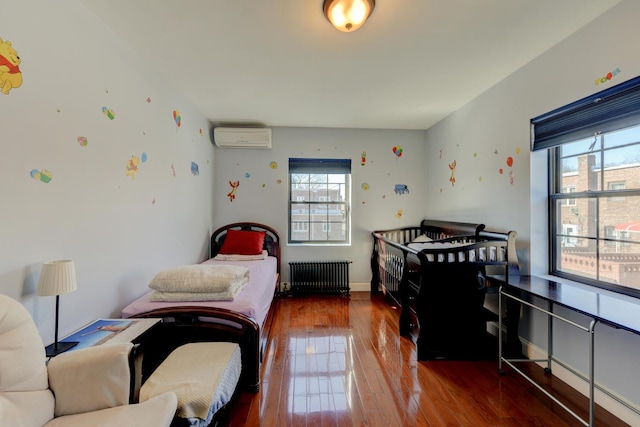 67-54 Groton St, Forest Hills, NY 11375 - bedroom featuring hardwood / wood-style flooring, radiator, an AC wall unit, and multiple windows