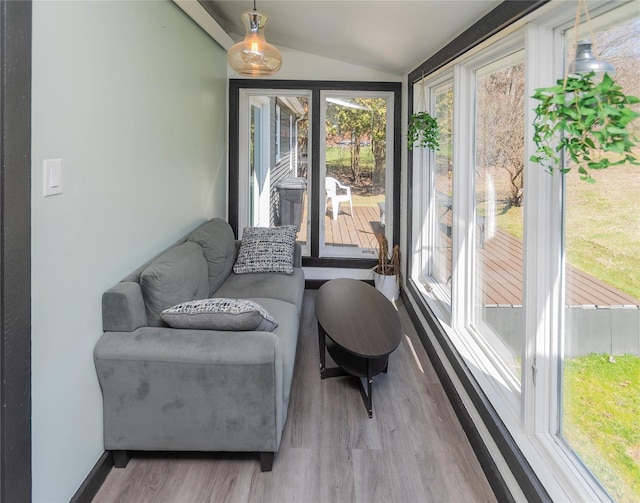 sitting room with lofted ceiling and light wood-style flooring