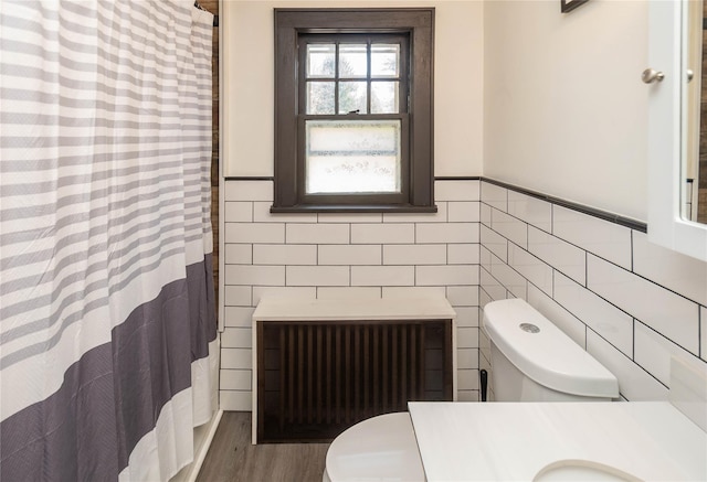 full bath featuring radiator, toilet, vanity, tile walls, and a shower with shower curtain