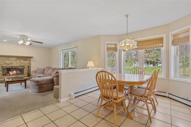 dining area featuring plenty of natural light, baseboard heating, and light tile patterned flooring