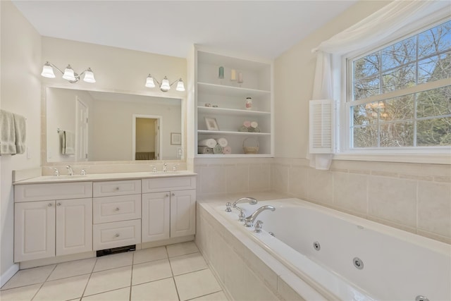 bathroom with a jetted tub, a sink, tile patterned floors, and double vanity