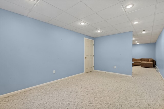 interior space with baseboards, carpet flooring, a drop ceiling, and recessed lighting