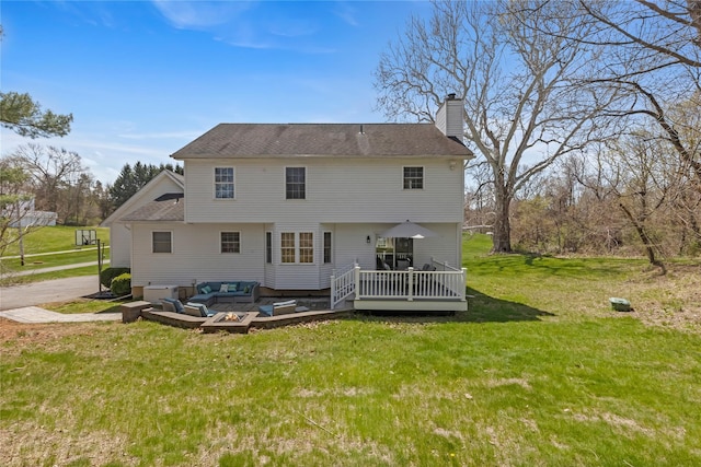 back of house featuring a wooden deck, roof with shingles, a chimney, an outdoor hangout area, and a lawn