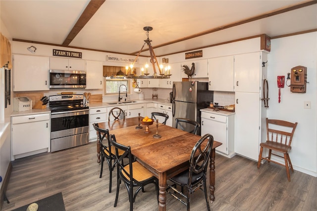 dining area featuring dark wood finished floors, beam ceiling, and a notable chandelier