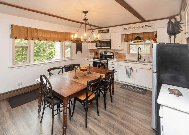 dining area with wood finished floors and a notable chandelier