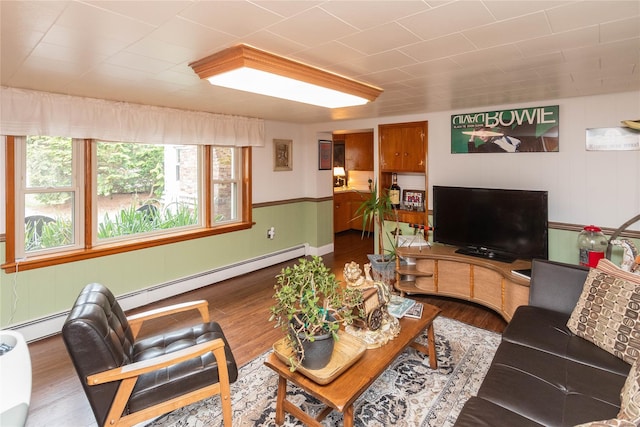 living area with wood finished floors and a baseboard radiator