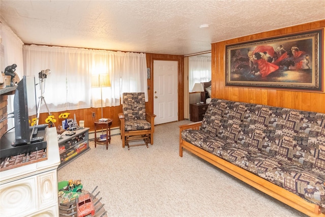 living room featuring a baseboard heating unit, carpet flooring, and wooden walls