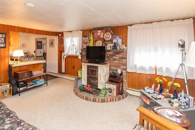 living room with wooden walls, carpet floors, and baseboard heating