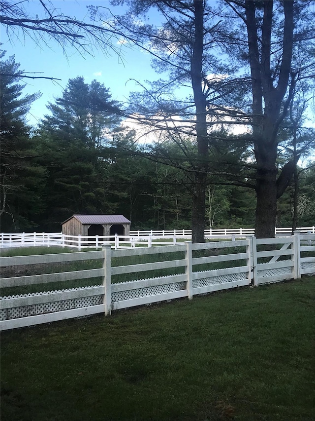 view of yard featuring an outdoor structure and fence
