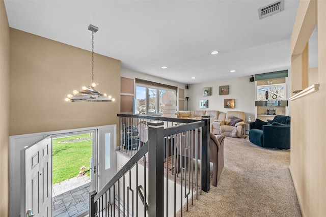 hall featuring carpet flooring, an upstairs landing, visible vents, and recessed lighting