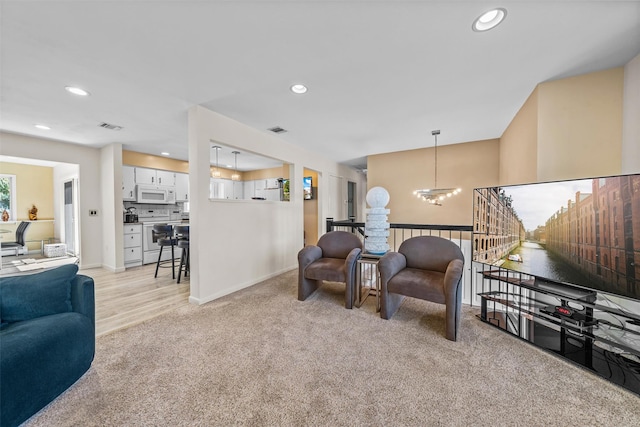 living room with a chandelier, visible vents, and recessed lighting