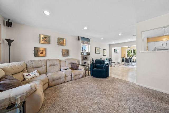 living room featuring baseboards, carpet floors, and recessed lighting