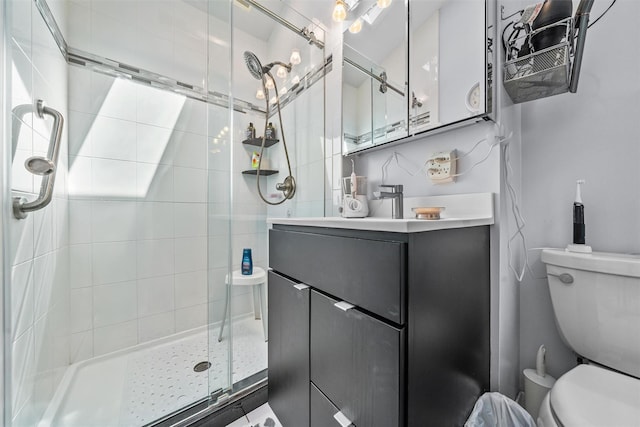 bathroom featuring a shower stall, toilet, and vanity