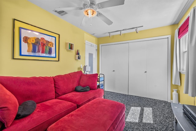 living area with track lighting, ceiling fan, carpet floors, and visible vents