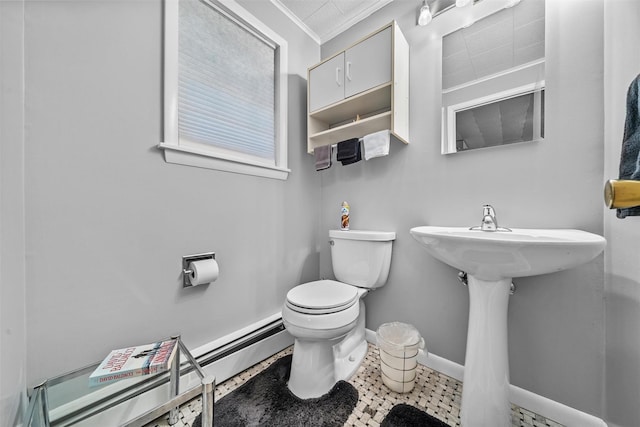 half bathroom featuring a baseboard heating unit, toilet, ornamental molding, and baseboards