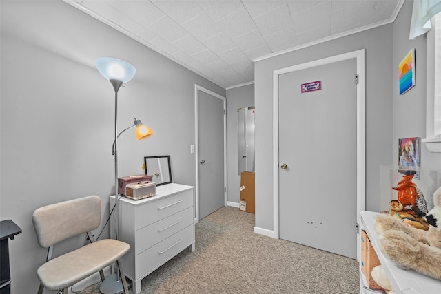 bedroom with baseboards, crown molding, and light colored carpet