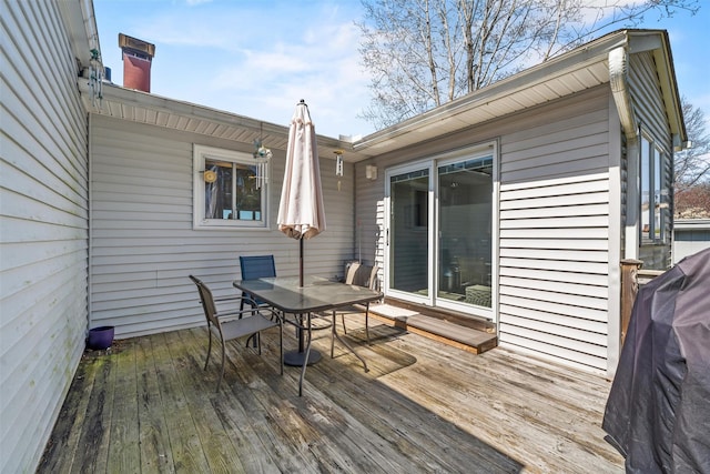 wooden terrace with outdoor dining area