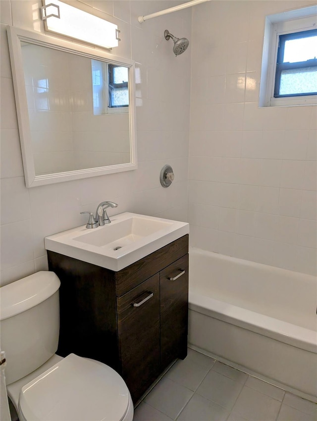 full bathroom with tile patterned floors, toilet, tile walls, shower / bath combination, and vanity