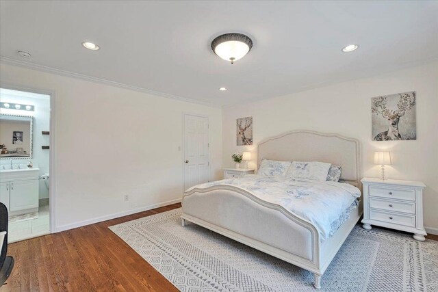 bedroom with crown molding, recessed lighting, baseboards, and wood finished floors