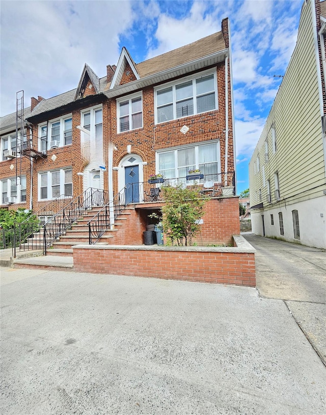 townhome / multi-family property featuring brick siding