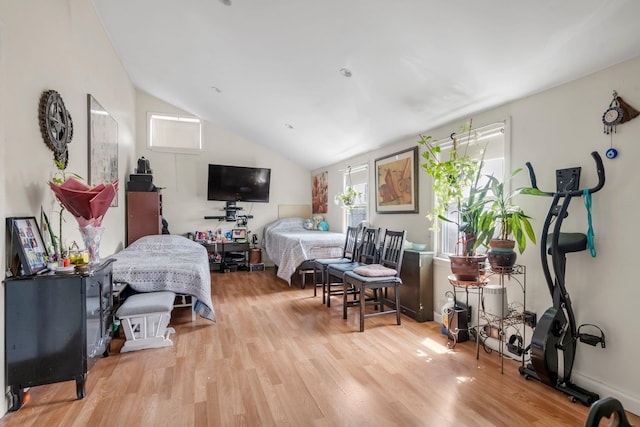 bedroom featuring lofted ceiling and wood finished floors