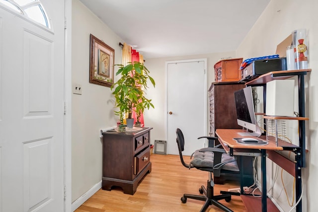office with light wood-type flooring and baseboards