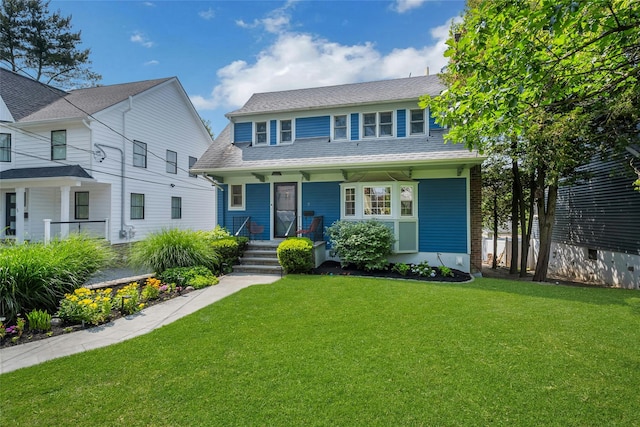 7 Senate Pl, Larchmont, NY 10538 - view of front of house with a porch, a front lawn, and roof with shingles