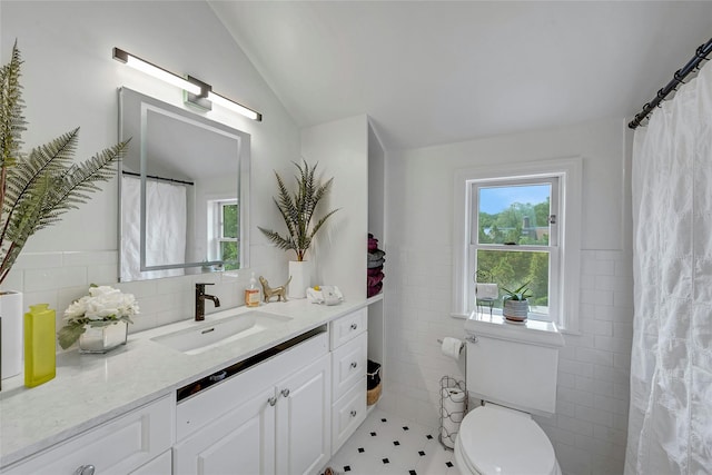 7 Senate Pl, Larchmont, NY 10538 - full bath featuring tile walls, vanity, healthy amount of natural light, toilet, and vaulted ceiling