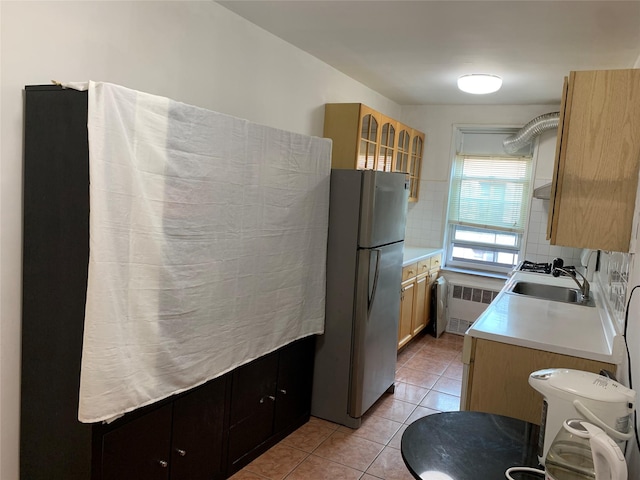 42-40 Bowne St Unit 6D, Flushing, NY 11355 - kitchen with freestanding refrigerator, a sink, radiator heating unit, light countertops, and light tile patterned floors