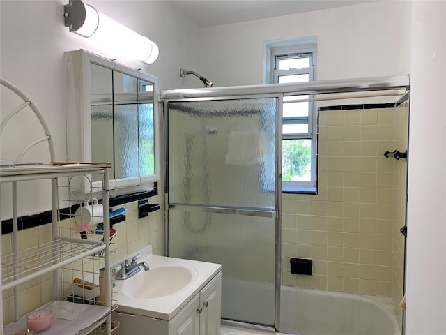 42-40 Bowne St Unit 6D, Flushing, NY 11355 - bathroom featuring vanity, combined bath / shower with glass door, and tile walls