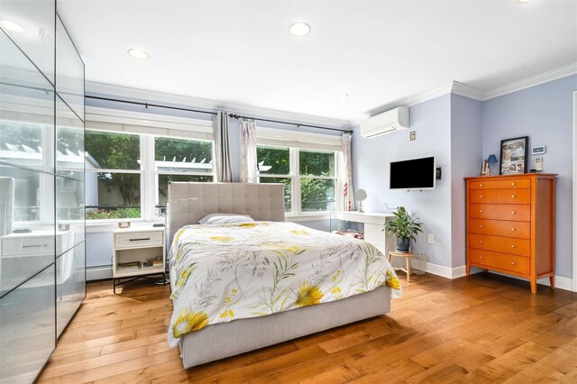 bedroom featuring a wall mounted air conditioner, light wood-style floors, baseboards, ornamental molding, and recessed lighting