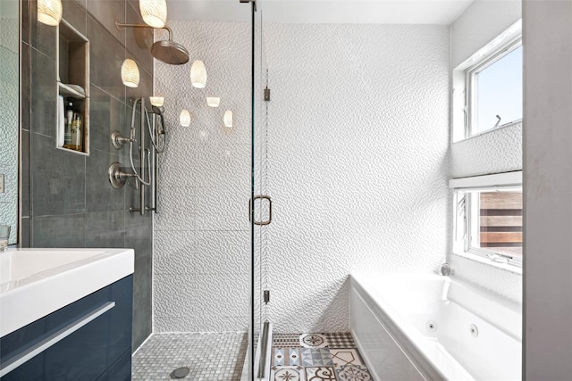 full bath featuring a whirlpool tub, a shower stall, a wealth of natural light, and tile patterned floors