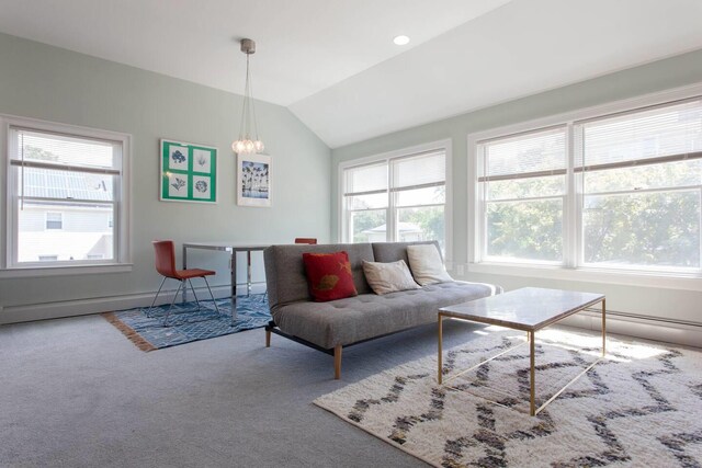 living area with vaulted ceiling, a chandelier, and carpet