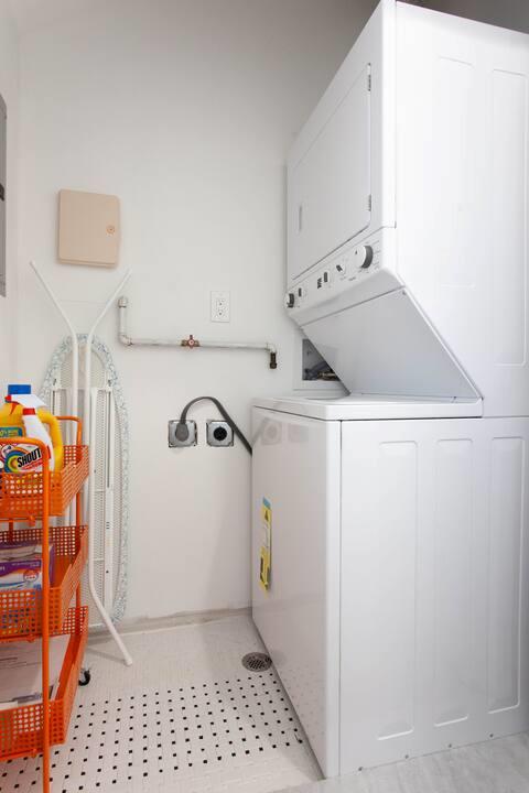laundry room with stacked washing maching and dryer and laundry area