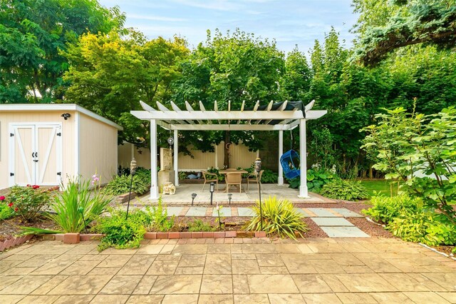 view of patio / terrace with an outdoor structure, a pergola, and a storage unit