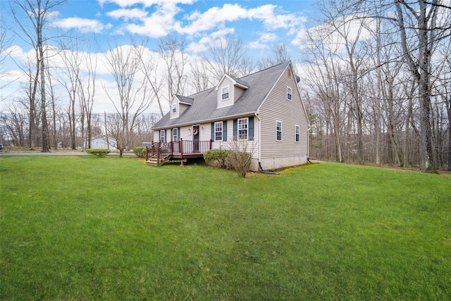 exterior space featuring a wooden deck, roof with shingles, and a front lawn