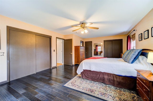 bedroom with multiple closets, wood finished floors, and a ceiling fan