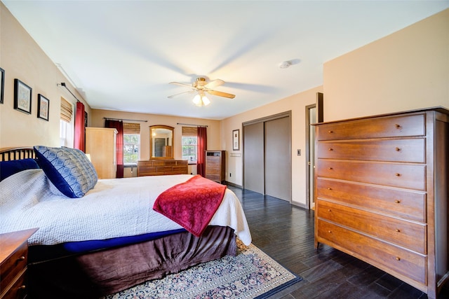 bedroom with wood finished floors, a closet, a ceiling fan, and baseboards