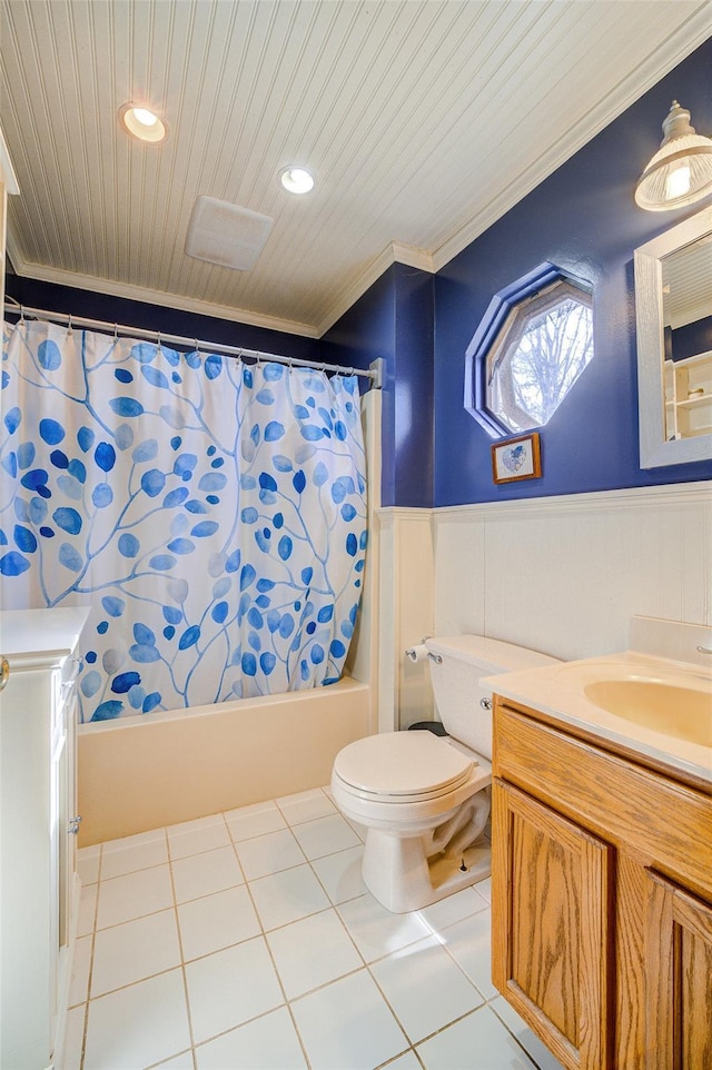 full bathroom featuring crown molding, toilet, vanity, and wainscoting