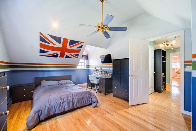 bedroom featuring hardwood / wood-style flooring, vaulted ceiling, and a baseboard heating unit