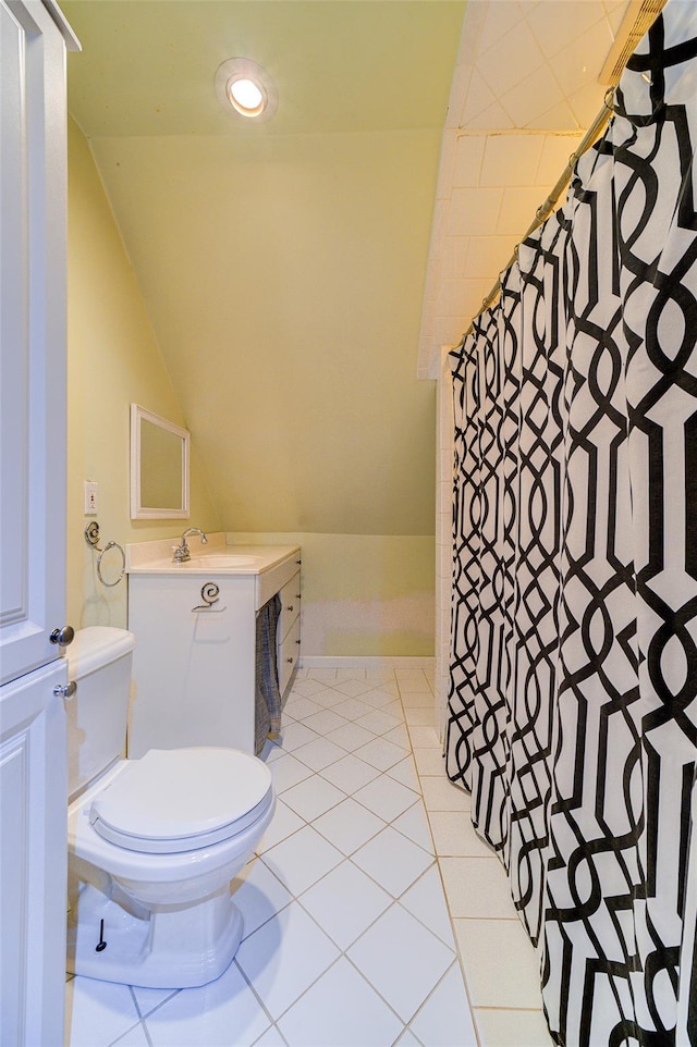 bathroom with tile patterned flooring, vaulted ceiling, toilet, and vanity