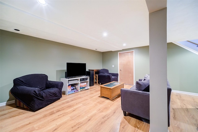 living area featuring baseboards, wood finished floors, and recessed lighting
