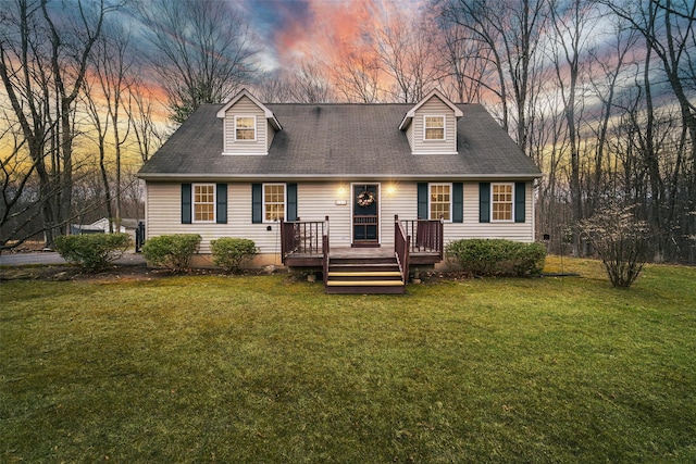new england style home featuring a lawn and a deck