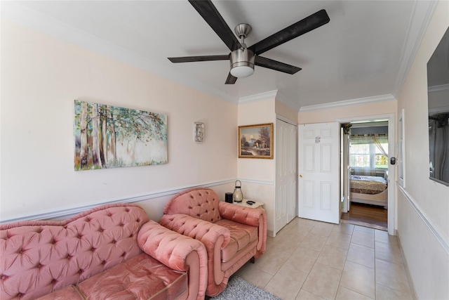 living room with ceiling fan, crown molding, and light tile patterned flooring