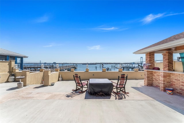 view of patio with a water view
