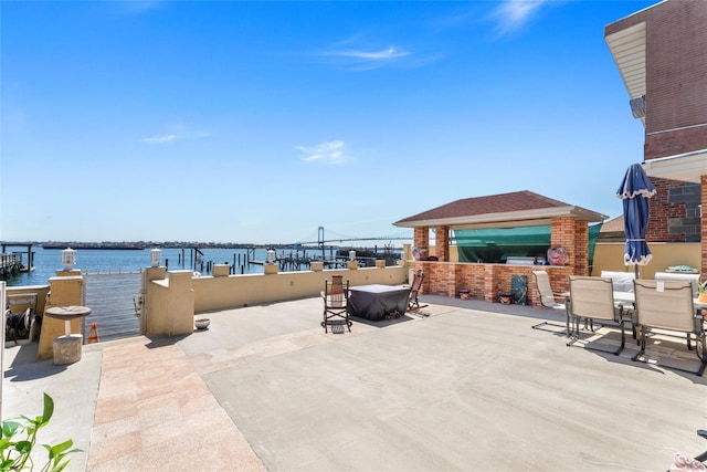view of patio / terrace with outdoor dining area and a water view