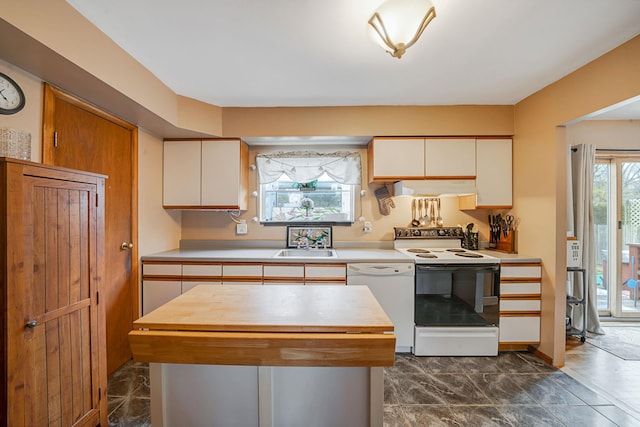 kitchen featuring a sink, white cabinetry, white appliances, range hood, and wood counters