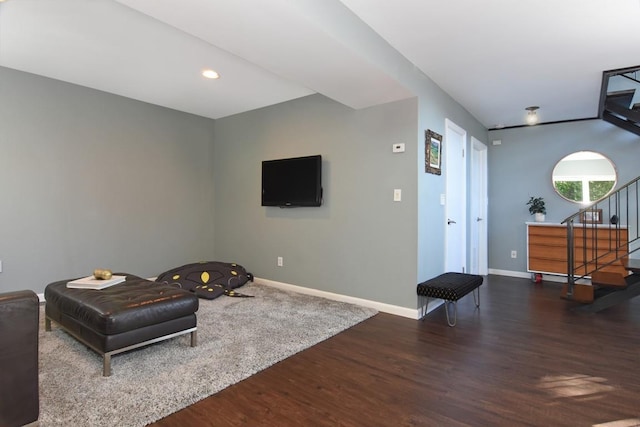 living area with recessed lighting, wood finished floors, baseboards, and stairs